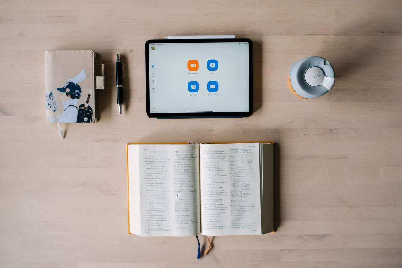 bible, tablet, diary and coffee on a table