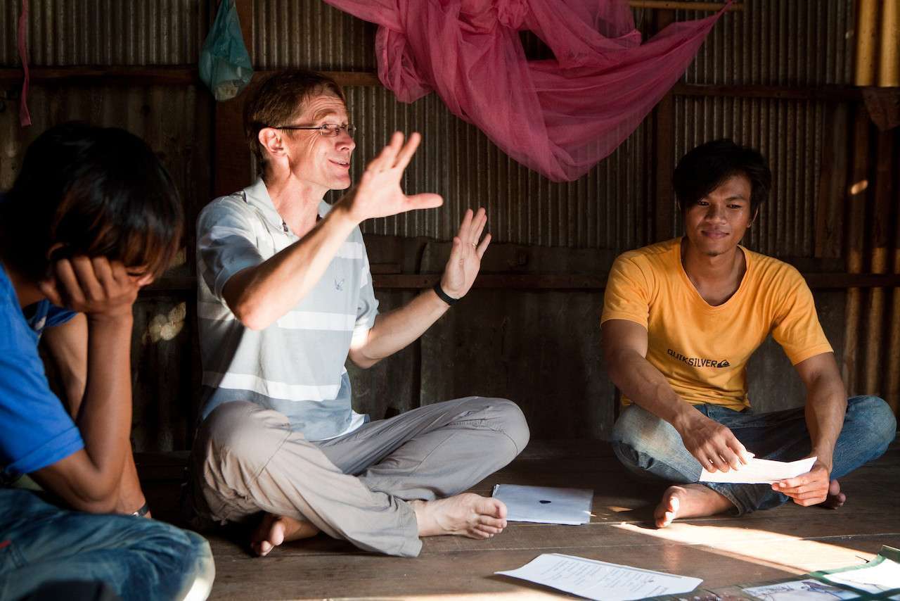 a man interacting with a group of east asian people