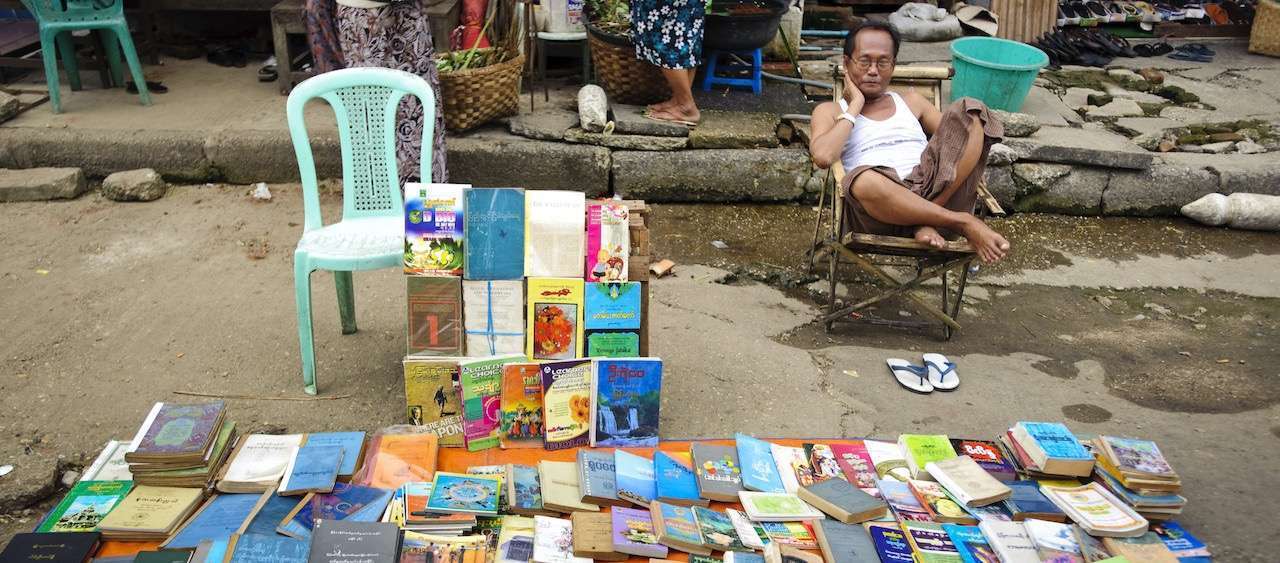 man displaying books