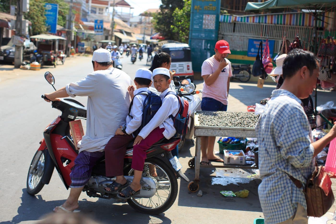 A Muslim family make their way through a market on the outskirts of Phnom Penh.