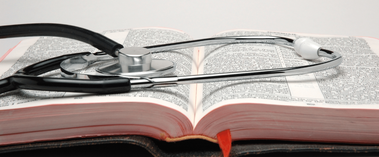 A stethoscope on an open Bible